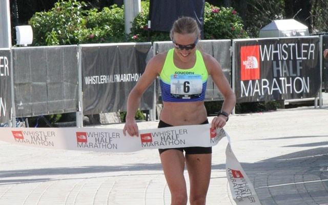 Sweet souvenir Marilyn Arsenault holds onto the finish-line ribbon after winning the women's race at The North Face Whistler Half Marathon on June 6. Photo by Dan Falloon