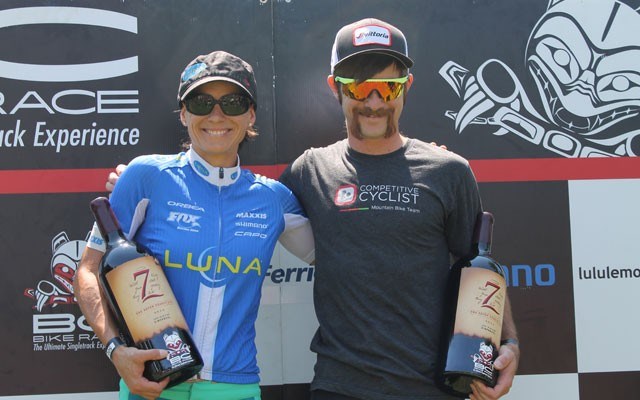 Katerina Nash and Tristan Uhl celebrate their BC Bike Race victories in Whistler Olympic Plaza on July 4. Photo by Dan Falloon