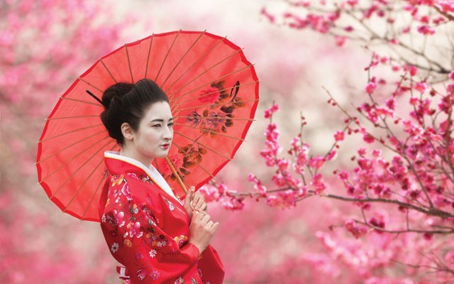 These young Japanese women dress in traditional kimonos while visiting Kiyomizu-dera Temple in Kyoto. They are writing down their prayers during a special flower festival. Shutterstock photo