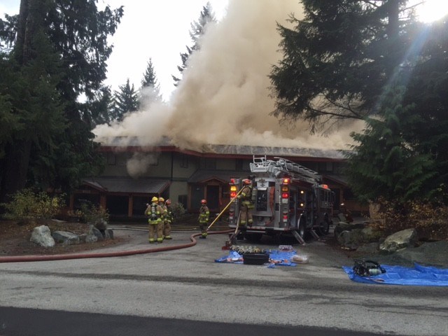 BATTLING BLAZE Firefighters work to control morning fire at 8100 Alpine Way, Alpine House. PHOTO BY ALISON TAYLOR