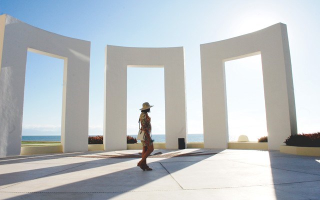 The walkway to the pool bar is punctuated by geometric arches. Photo By Steve MacNaull