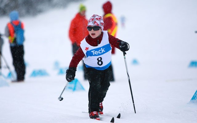 Happy skier Whistler Nordics' Van McDonnell, competing in the atom boys' division, enjoys his first-ever cross-country ski race. Photo by Sea to Sky Photography