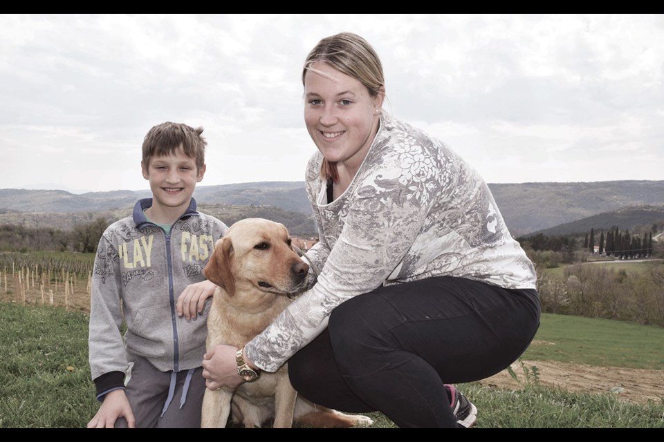 Rok Rodica, left, with Liza the truffle-hunting dog and handler Sara Kocjancic. Photo by Steve MacNaull