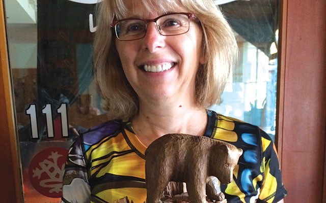 Moving Tribute Sylvia Dolson of Get Bear Smart with the bear altar in honour of black bear Slip, sent to her by German supporter Bernhard Seuss. PHOTO by Cathryn atkinson
