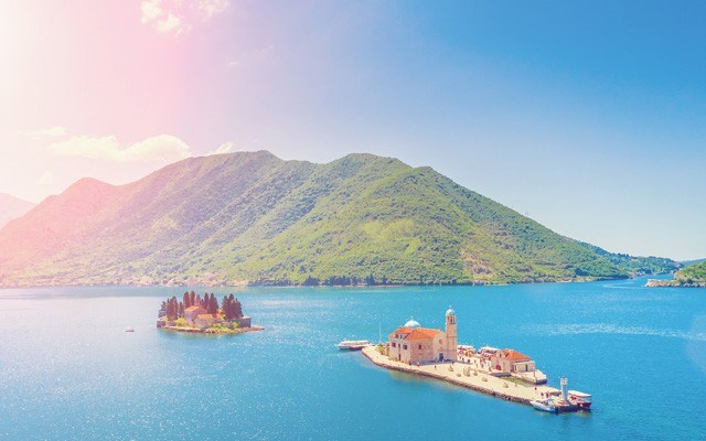 View of the island of Our Lady of the Rocks and island of St. George in the sunshine. Photo from <a href="http://shutterstock.com">shutterstock.com</a>