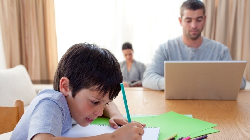 family-in-condo-child-drawing-parents-working-from-home