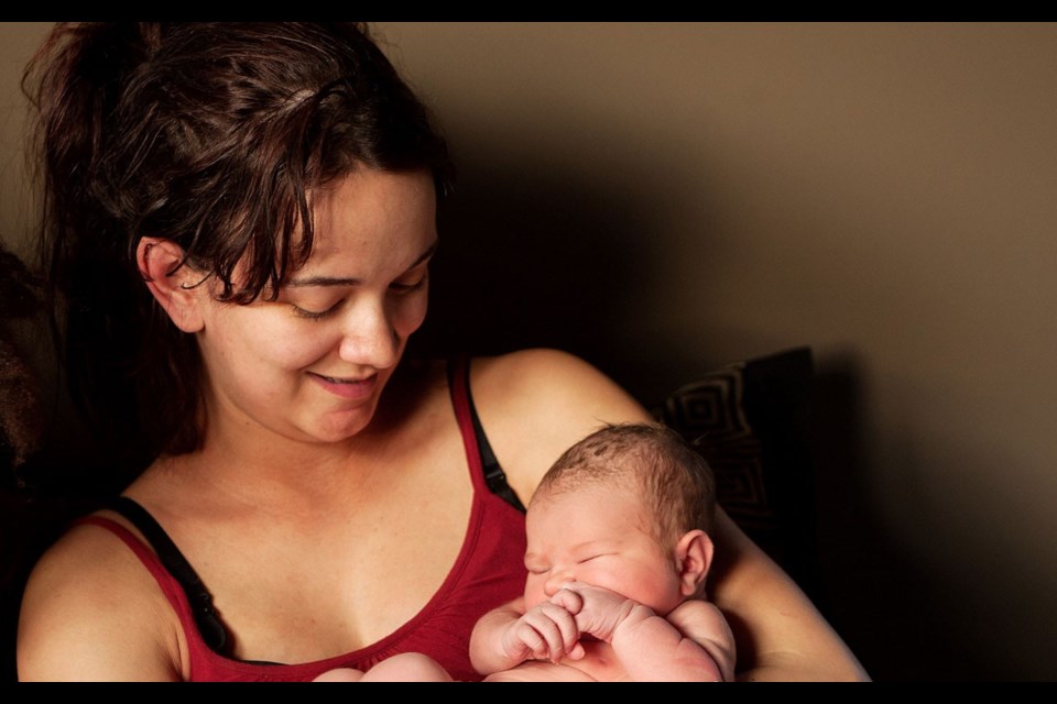 NEW YEAR'S GIFT Mom Larissa Dasse holds newborn Lillianna Skye Dasse Rivait. Photo by Dave Buzzard courtesy of Squamish Chief