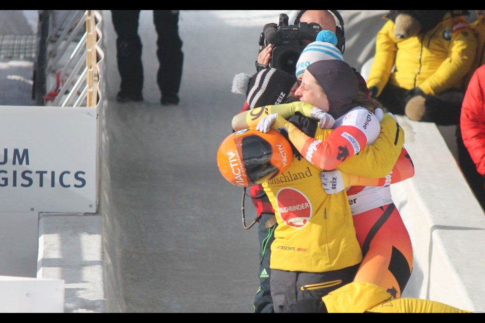 Germany's Tina Hermann (right) is hugged by teammates Sophia Griebel (left) and Jacqueline Loelling (back) after winning the women's skeleton event at the BMW IBSF World Championships at Whistler Sliding Centre on Friday. Photo by Dan Falloon