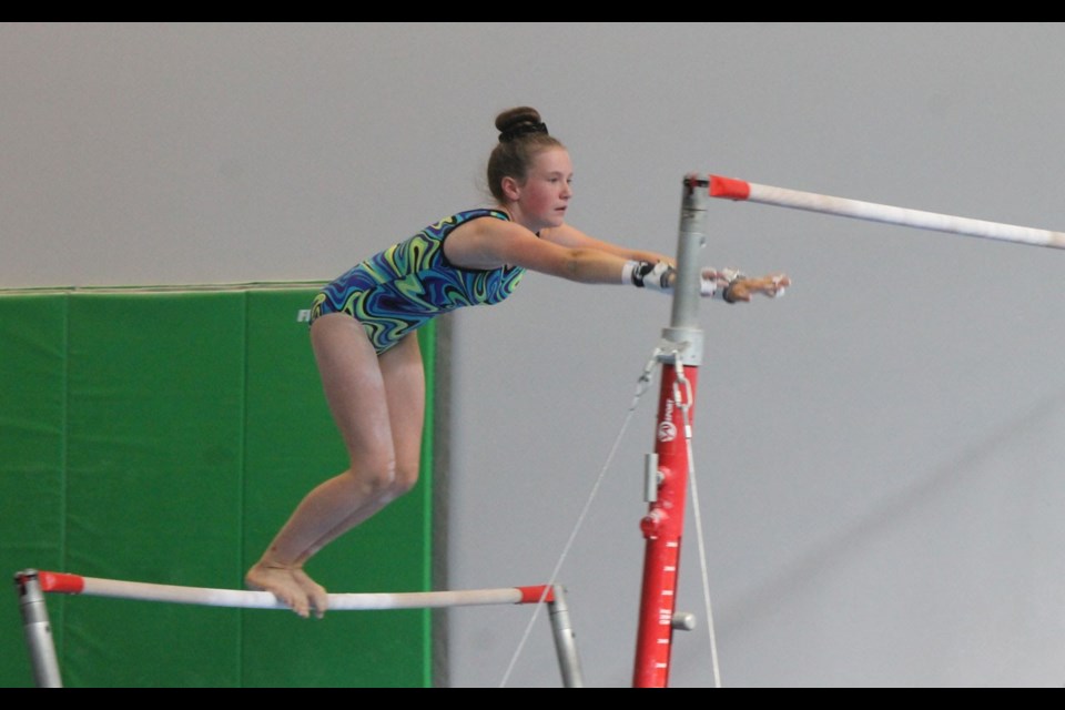 FIRTH IN FIRST Sophie Firth, shown here competing on the bars, tied for first in her division during the Whistler Spring Classic from June 21 to 23. <ParaStyle:CUTLINE\:CUTLINE Credit>Photo by Dan Falloon