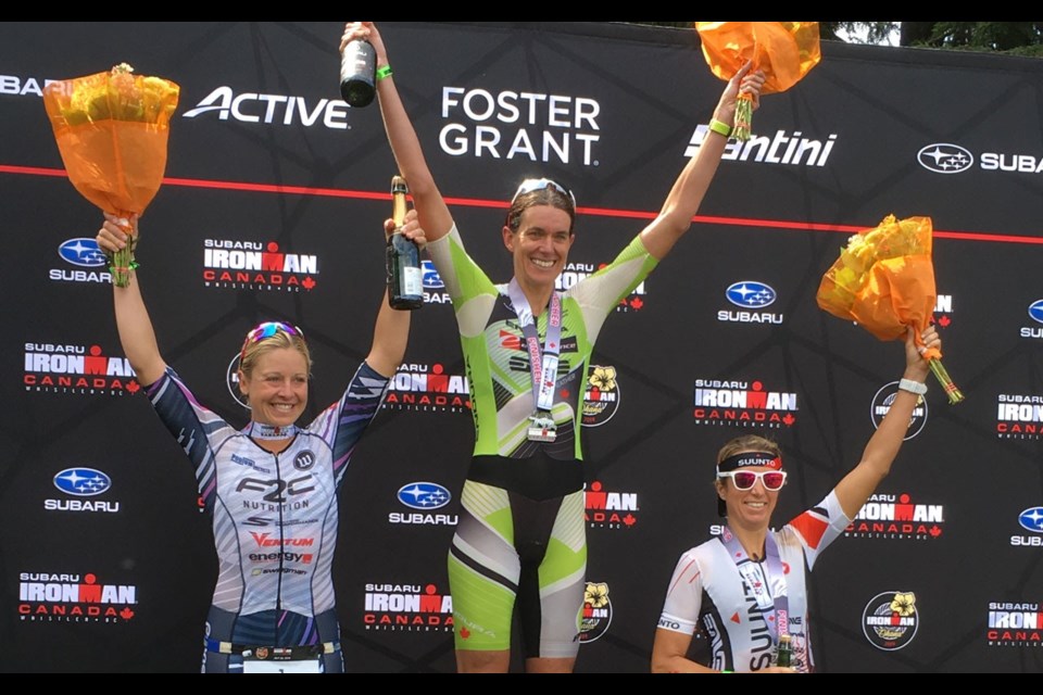 Kelowna's Heather Wurtele (centre) celebrates her Subaru Ironman Canada win alongside runners-up Jen Annett (left) and Kelsey Withrow (right). Photo by Dan Falloon