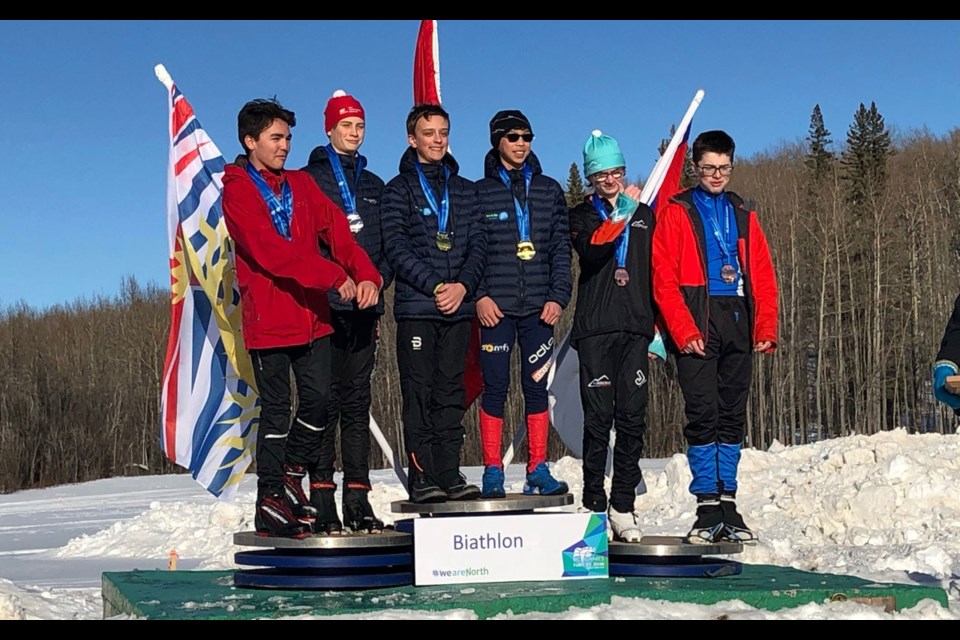 Sea to Sky Nordics biathletes Ryan Clark and Jojo Ng (centre) accept their team relay gold medals at the BC Winter Games on Feb. 21. Photo submitted