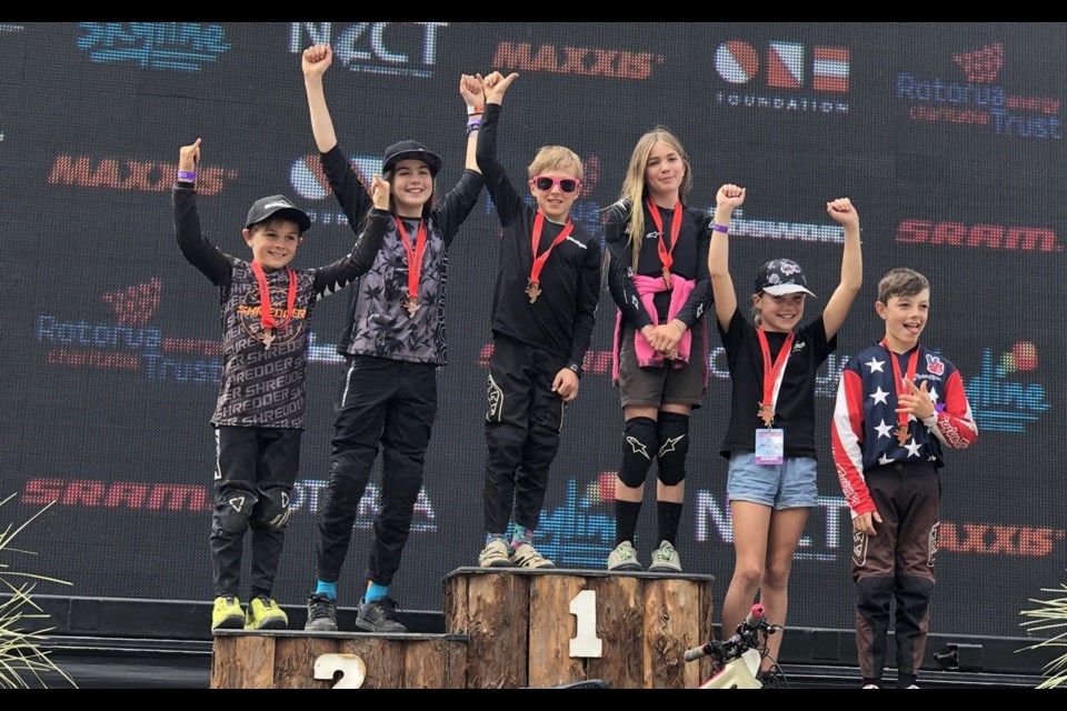 Landon de Vall (third from left) and Cami Bragg celebrate their podium appearance in the Kidsworx DH. Photo submitted