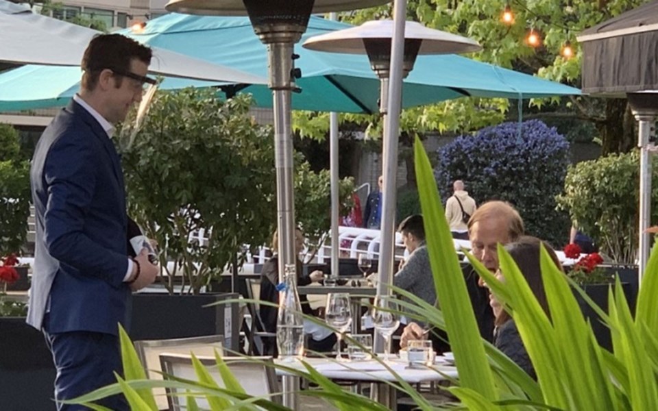 a-server-at-ancora-restaurant-wears-a-face-shield-to-prevent