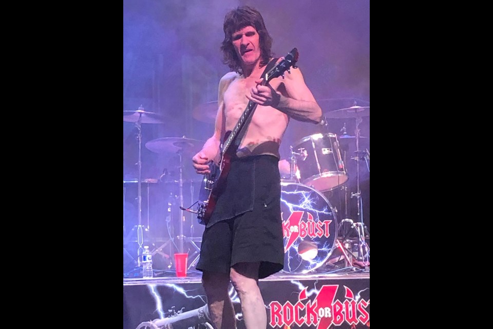 RETRO ROCKER: Rob MacDougall [above] played the part of lead AC/DC guitarist Angus young when tribute band Rock or Bust entertained an audience at Evergreen Theatre on May 21. 