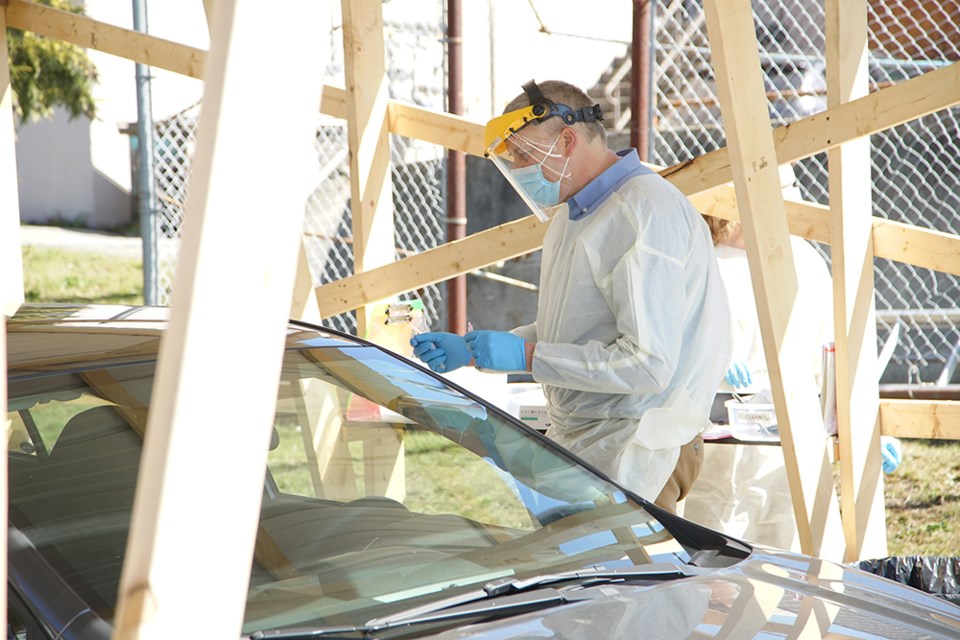 GETTING TESTED: Dr. Stephen Burns takes a COVID-19 sample at the Medical Clinic Associates drive-through. Powell River residents are being vaccinated against the coronavirus at Powell River Recreation Complex and at local pharmacies.                               