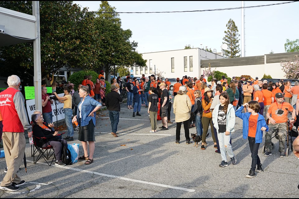 A large number of people, many wearing orange shirts, assembled at Powell River City Hall on May 4 to support a name change for the city.