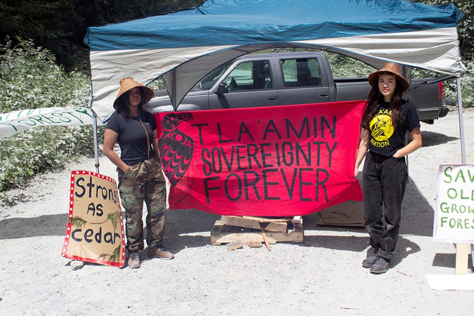 Jegajimouxw [right] and Thich’ala set up a blockade at a Western Forest Products access road in qathet Regional District on June 23.