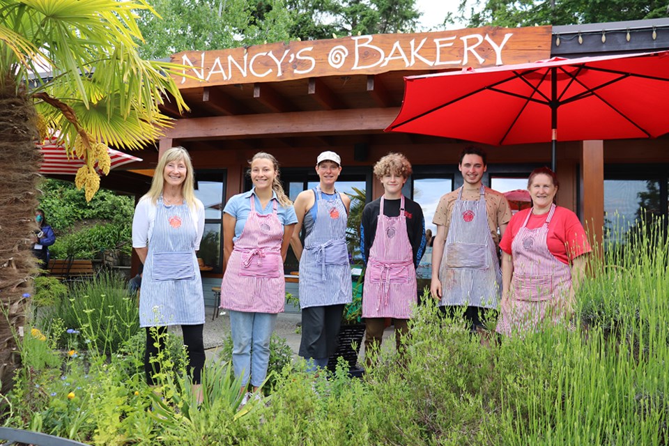 BAKING TEAM: Nancy’s Bakery owner Nancy Bouchard [left] and employees [from second left] Allison Derksen, Christy Krebber, Kiram Hollman Prichard, Matt Cappiello and Pip Hendy recently took a minute (no exaggeration, it’s a busy place) to gather for a photo outside of the third location the business has operated at in Lund since 1991.