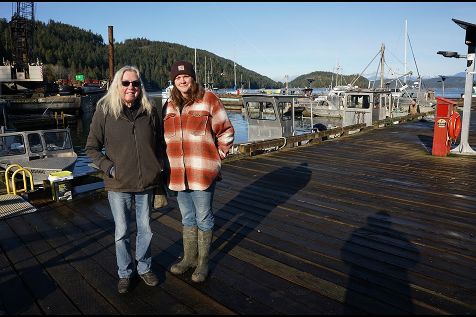 BIG CHANGES: Okeover Harbour Authority accountant administrator Lynn Paris [left] and wharfinger Krystle Goddard indicate that reconstruction of the wharf has made for a significant change to the harbour, which will make a real difference for harbour users when construction is complete.                               