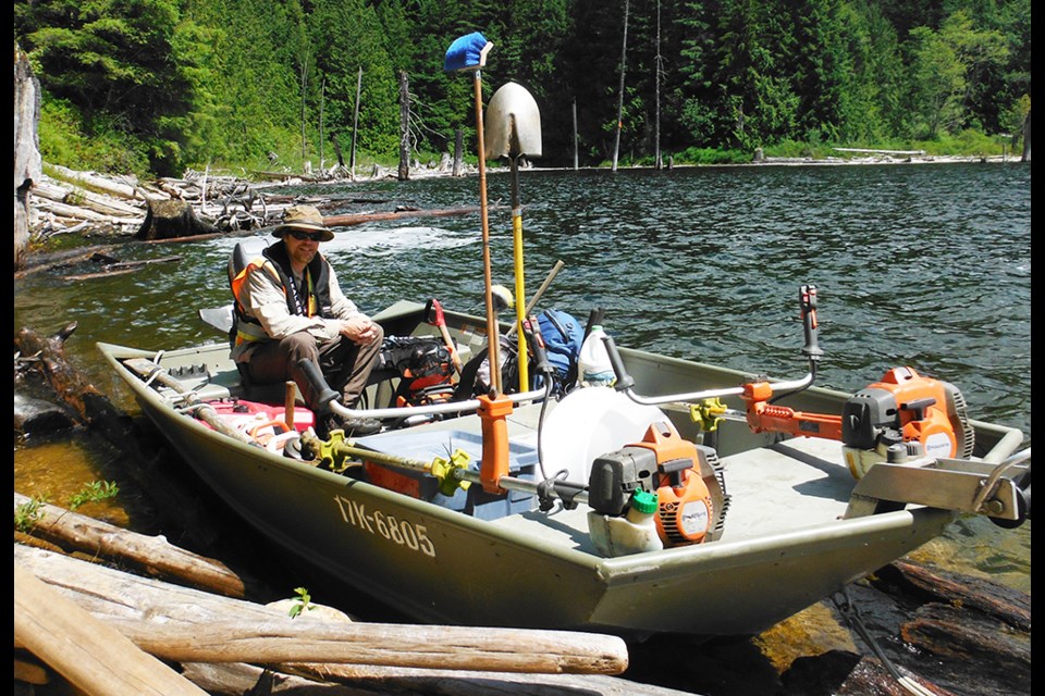 PROVIDING GUIDANCE: Powell Forest Canoe Route project manager Hugh Prichard, seated in the project’s maintenance boat, has been actively coordinating Powell River Educational Services Society’s rehabilitation of the route, which features a number of improvements and upgrades to the infrastructure carried out by a crew hired through grant money to carry out the work.
