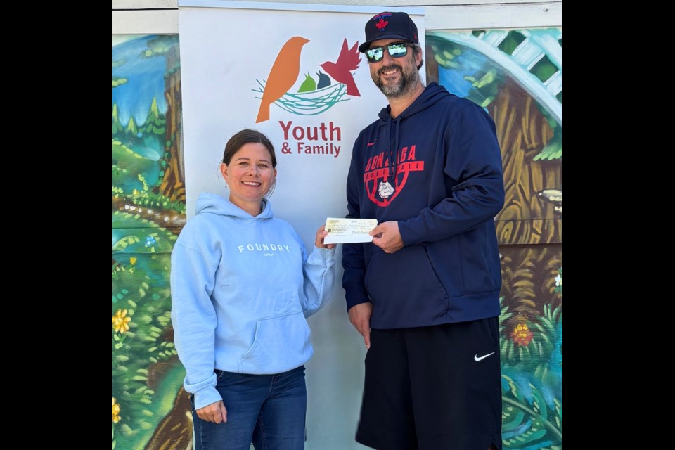 GOOD CAUSE: Wade's Cause slo-pitch tournament organizer Brandt Larson [right] hands a cheque for $6,000 to Foundry qathet communications lead Alice Ward Cameron.
