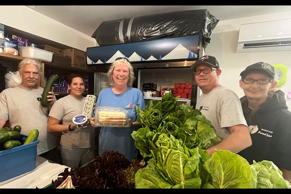 DEDICATED STAFF: Powell River Action Centre Food Bank manager Savanna Dee [middle] with busy staff preparing bags of fresh produce for pickup by clients.