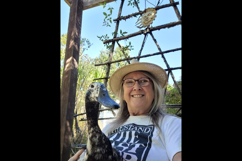 Powell River Garden Club president Lesley Moseley and Olimpia (named for the limp she has since a cougar attack) enjoying the cooler September sunshine.