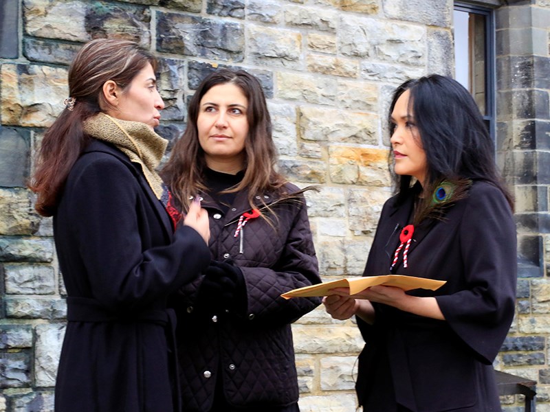 PLEADING FOR HELP: Yazidi refugee Adiba [left] with her Kurmanji interpreter Dilkhaz deliver a petition to the Canadian government asking for trauma counselling and other supports to be delivered as promised. MP Jenny Kwan [right] accepted the petition.