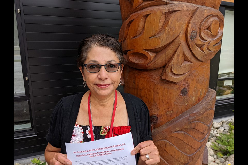 Patty Renton displays a letter she wrote and distributed as part of an effort to raise funds for residents of Lytton who have been displaced due to a wildfire.