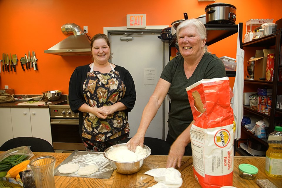 FUNDS PROVIDED: Powell River Brain Injury Society outreach worker Ginny Kuboniwa [left] and Jeanette Francis are working in the kitchen for the Friday feast, where clients get access to healthy foods. The society has received money from the province through the Brain Injury Alliance to run programs, including a nutrition, cooking and gardening program.                               