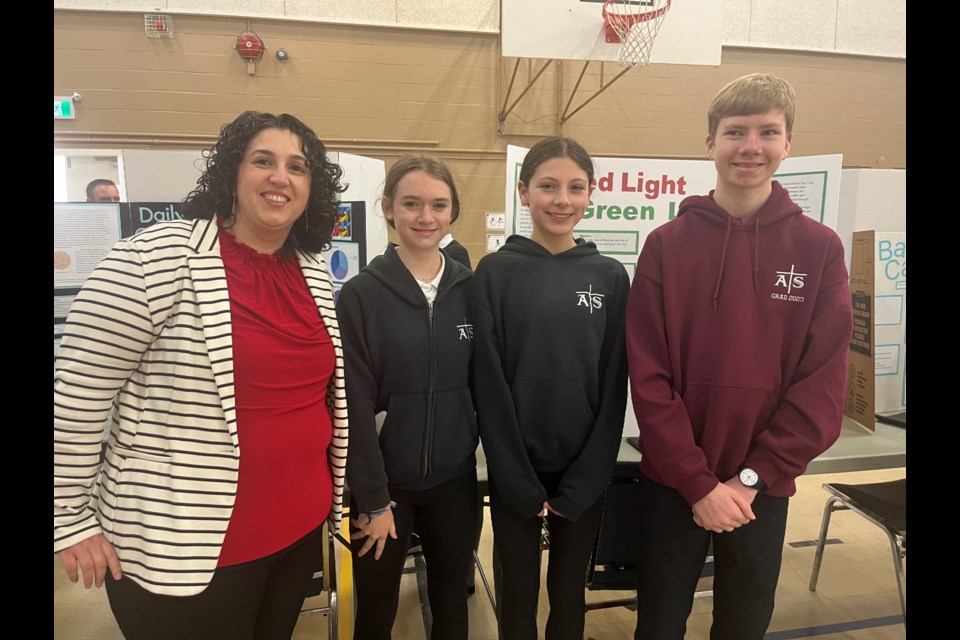 SCIENTIFIC METHOD: Teacher Angela Bennett stands with her students in the Assumption Catholic School gym in Powell River. She is proud of her students' ability to come up with unique experiments.