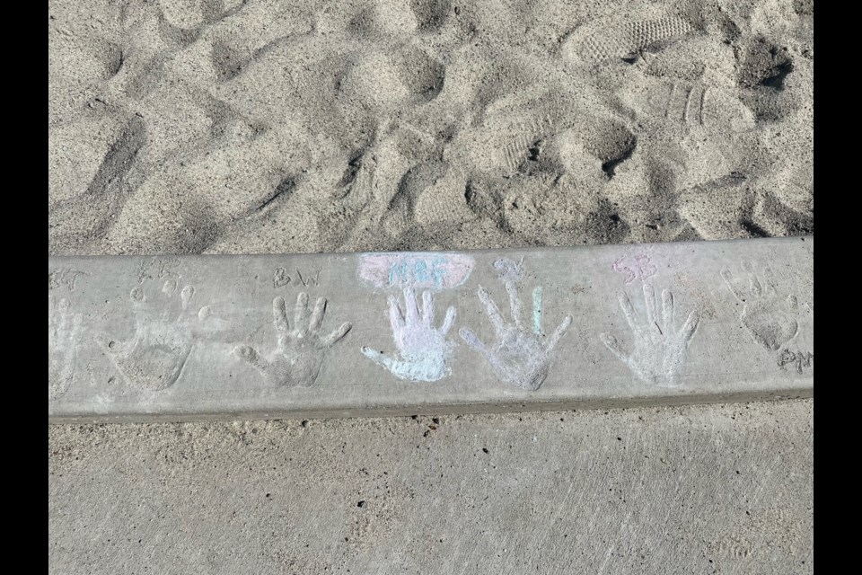 HAND PRINT: Henderson Elementary School students made hand prints in newly poured concrete around the perimeter of the playground.

