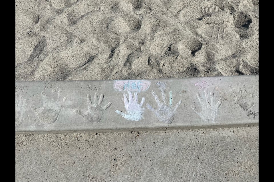 HAND PRINT: Henderson Elementary School students made hand prints in newly poured concrete around the perimeter of the playground.

