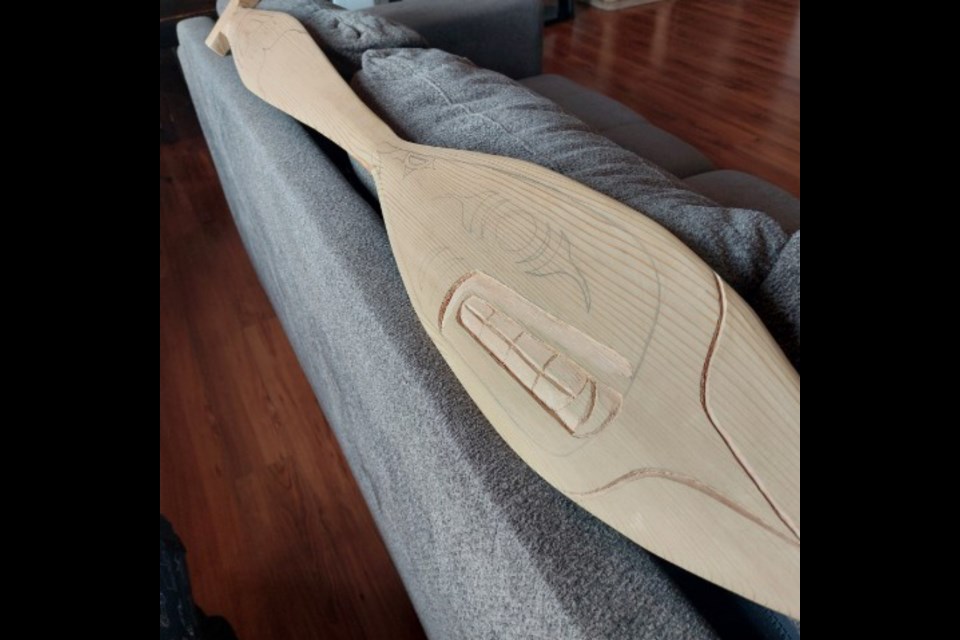 CEDAR PADDLE: Tla’amin carver Craig Galligos is working on a red cedar paddle [above] to be presented as a prize at International Choral Kathaumixw 2023. In past years he carved large totem poles that were given as awards to the festival’s winners.