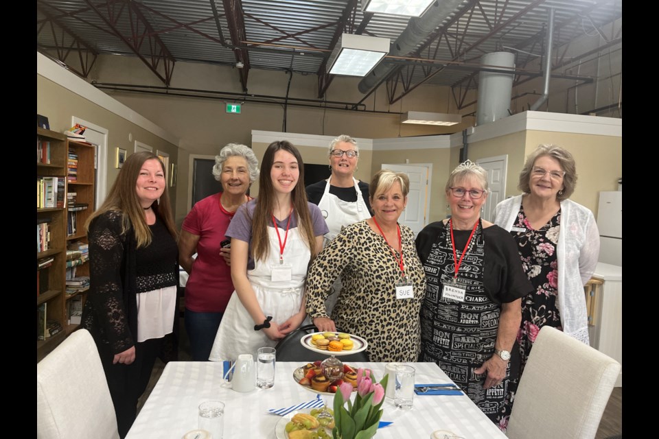 SPECIAL EVENT: [From left] inclusion Powell River administration assistant Serena Ross, Gerry Gray Place participant Helen Adams, volunteer Jenna Kowal, activities coordinator Jeanette Gardner, volunteers Sue Paquette and Brenda Powell, and manager of senior services Stacy Gibson recently prepared for a special coronation lunch to celebrate the crowning of King Charles III.