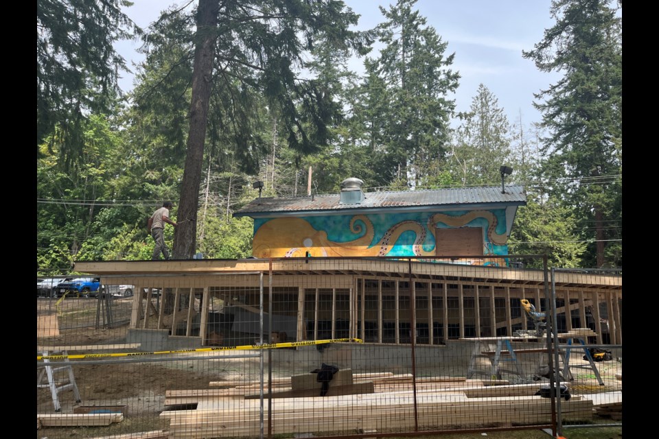 BEACH HUT UPDATE: Workers have been busy building a patio on the backside of the Beach Hut, at Willingdon Beach.  Christian Borrego is the artist behind the mural being painted on the back wall of the patio.
