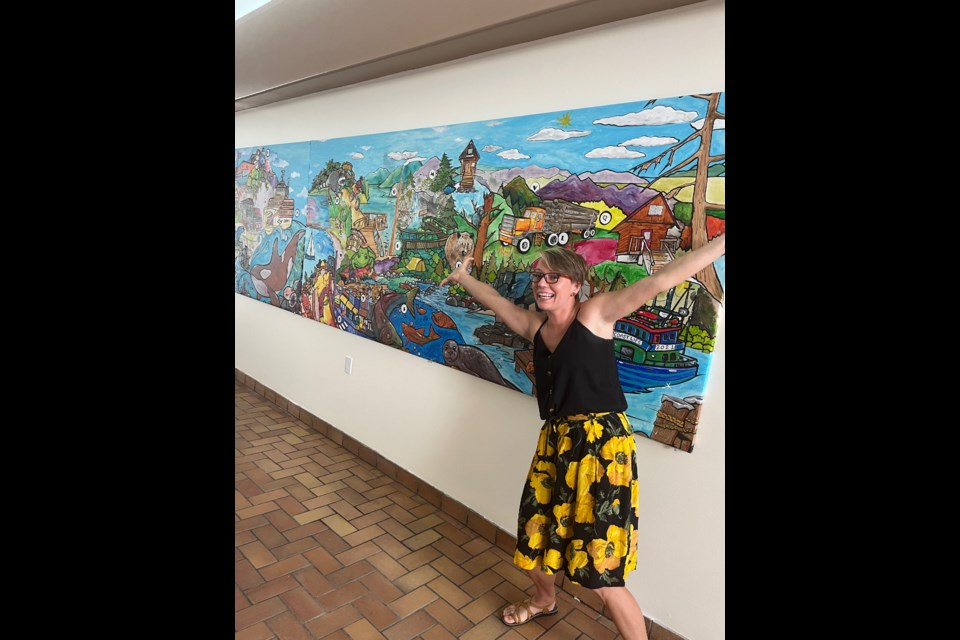 LITERACY LEGACY: Artist Sabrina Upton, who runs Gumboot Studio in Cranberry, celebrates the unveiling of the Legacy Wall at Powell River Town Centre mall. The mural is a collaboration between the artist and the community.