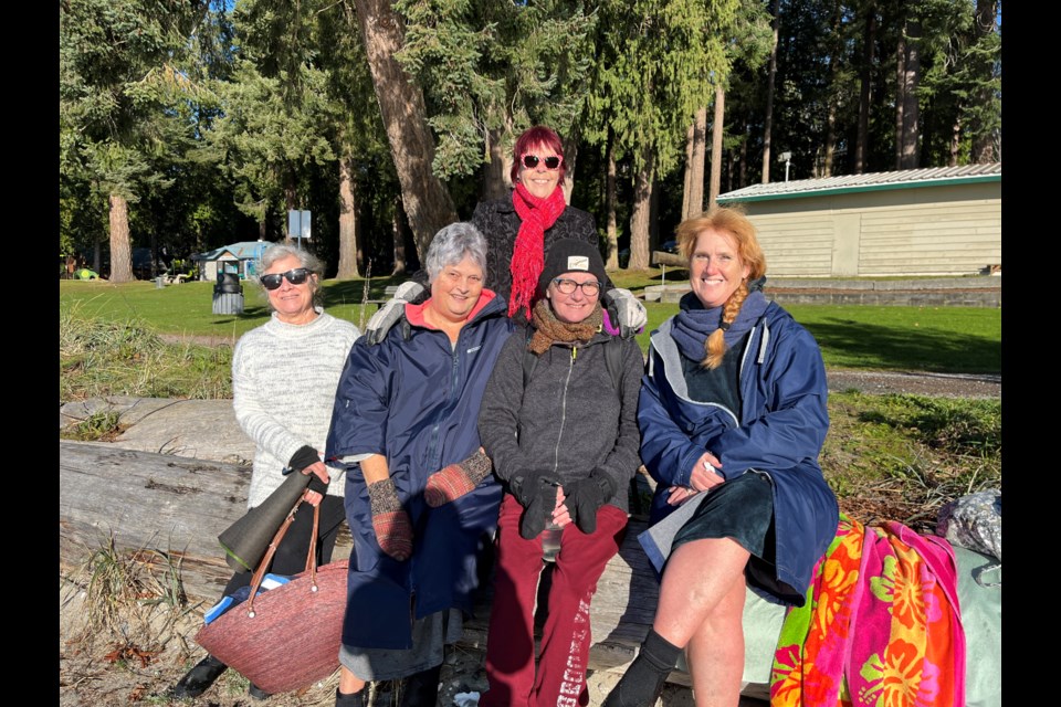 COLD WATER GROUP: A group of swimmers [from left] Terry Dahlgren, Deborah Calderon, Margo Lennon, Gerda Wever and Sherry Burton have been meeting at Willingdon Beach to swim in the ocean year-round and say they enjoy the practice.