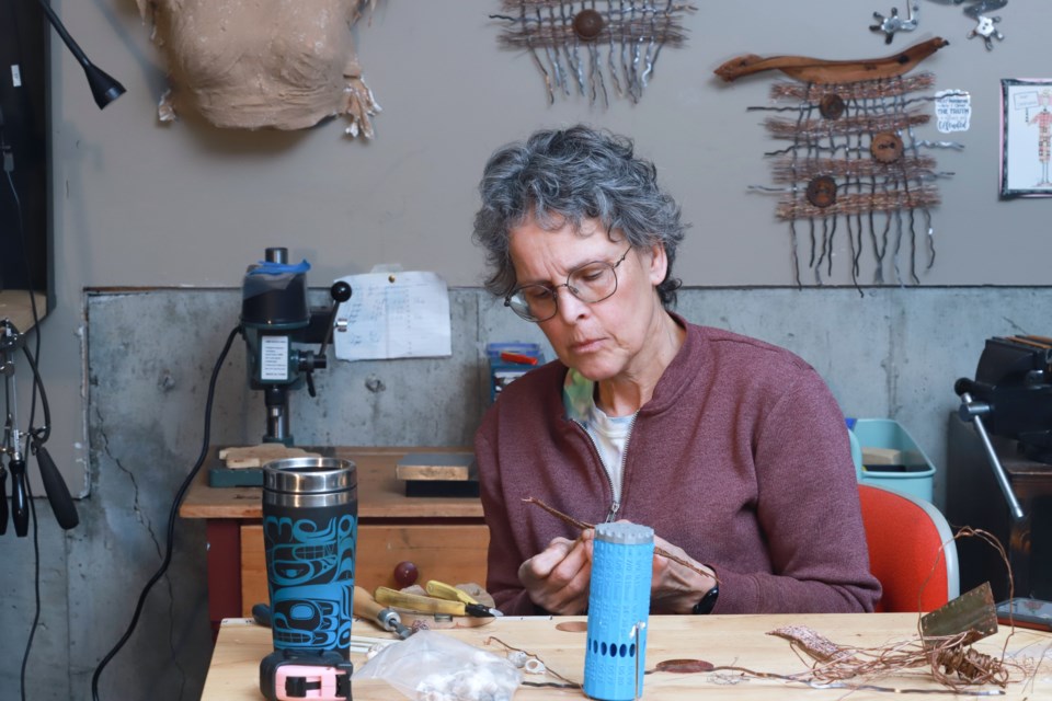 EARTH CONSCIOUS: Maker-artist Teresa Harwood-Lynn, organizer of Renew Art Faire, works with reclaimed metals and other found objects in her studio to create unique sculptures. 