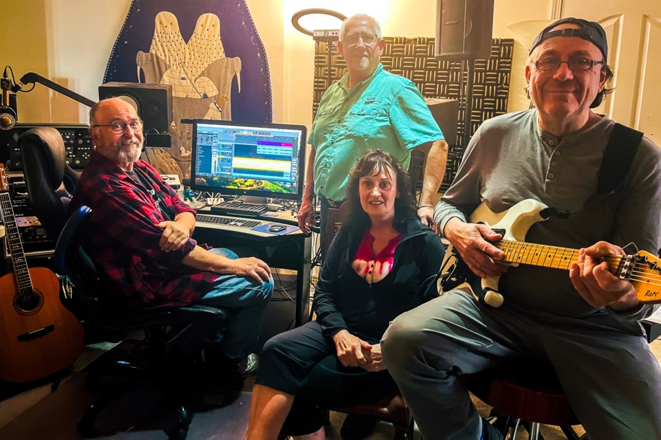STUDIO SESSION:Musicians [from left] Pat Buckna, Loren Halloran, Marion Keller and Ray Harvey are working on a recording of a song written by Halloran.
