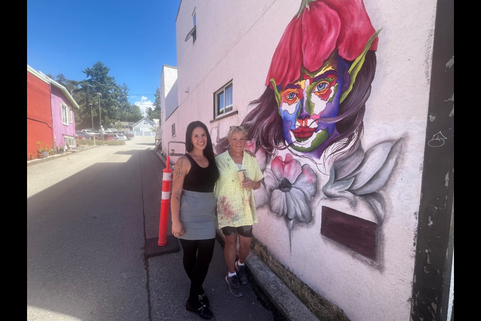 BLOOMING BEAUTIFICATION: Mural artist Maella Ginn [right] with Bloom Wildly shop owner Janet Lowes on Marine Avenue.
