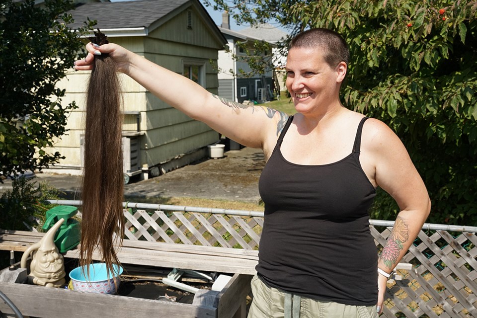 ROOT CAUSE: Tara Pinch, a relief oncology booking clerk at qathet General Hospital, shaved her head after the Tour de Friends (qathet) cycling team raised more than $5,000 for a ride in Victoria in support of BC Cancer Foundation. The hair will be donated for cancer survivors who have lost their own.                               