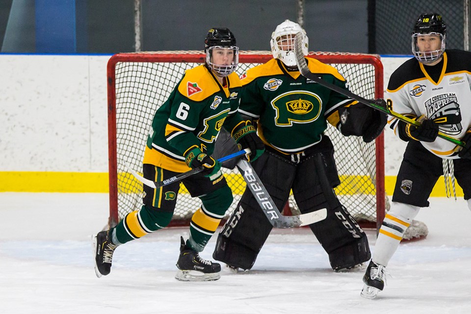 With Powell River Kings' defender Curtis Gould [left] looking on, a Coquitlam Express forward attempts to block the view of goaltender Nick Peters during a BC Hockey League game in Burnaby on April 24. Kings never trailed, but needed extra time to defeat the Express.