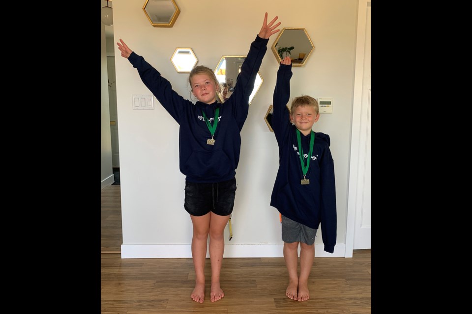 VAUNTED VAULTERS: Piper Van Tol [left], who won an award for the most powerful and dynamic vault, and Digory Van Tol, who earned gold on floor and vault, were local among competitors who excelled during the Ogopogo Invitational, held virtually, to close out the Powell River Gymnastics season.