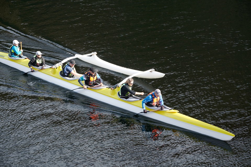 FIRST TEST: Members of Powell River Outrigger Canoe Society got a feel for one of their new boats, ARE Matahinas, during its maiden voyage on Powell Lake.