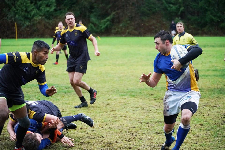 TOUGH COMPETITION: Powell River Otago Rugby Club players, wearing the blue jerseys, faced Nanaimo Hornets in an exhibition match at Cranberry Field in December, with the Vancouver Island side providing stiff competition for the locals.                               