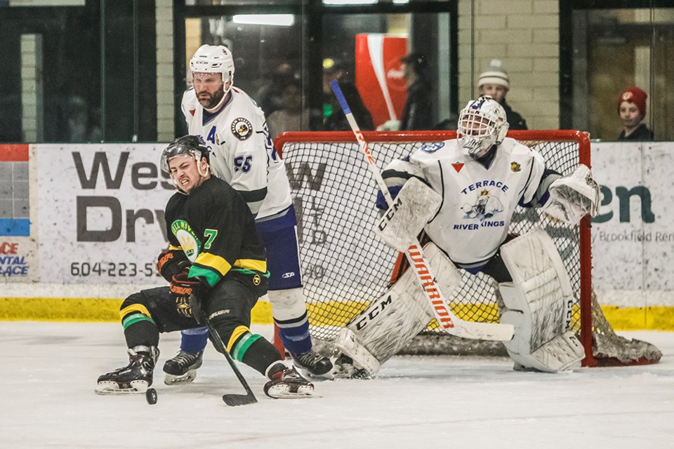 Powell River Regals' forward battles for puck possession in front of Terrace River Kings' net during a Coy Cup game at Hap Parker Arena on March 26.