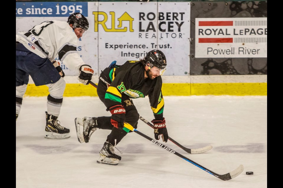 Powell River Regals' forward Nic Porchetta separates a Penticton Silver Bullets opponent from the puck during a Coy Cup game at Hap Parker Arena on March 27. Porchetta helped set up one goal in a 6-5 win for the tournament hosts.