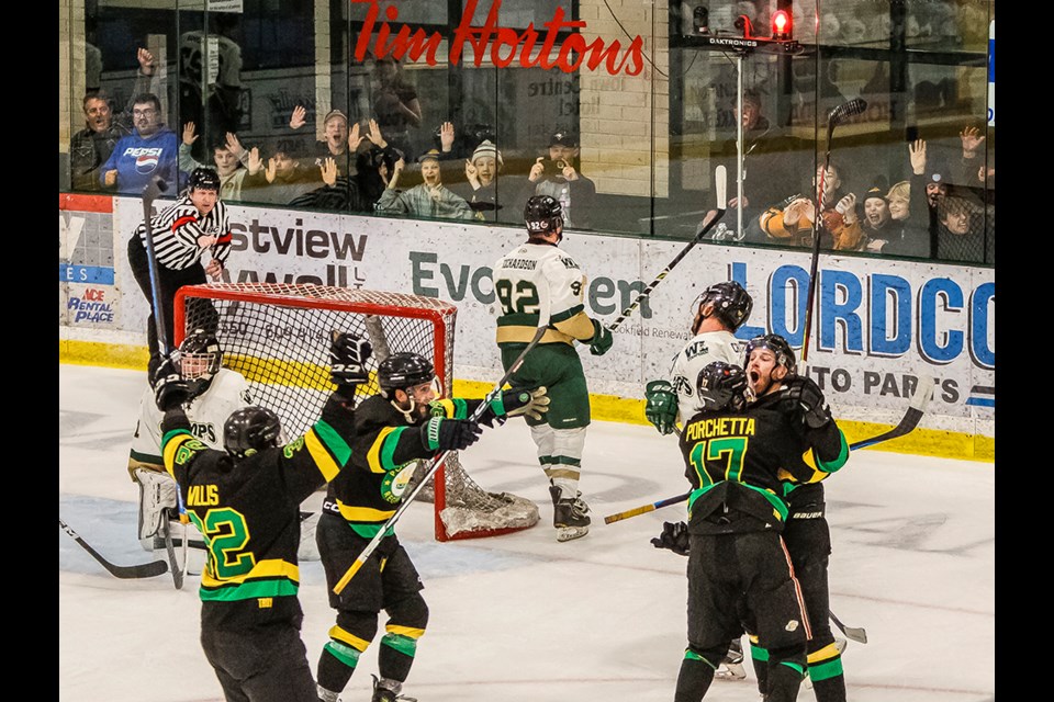 Nic Porchetta grabs Hunter Findlater, who scored the game-winning goal for Powell River Regals with 1:01 left in the Coy Cup semi-final at Hap Parker Arena on March 29.