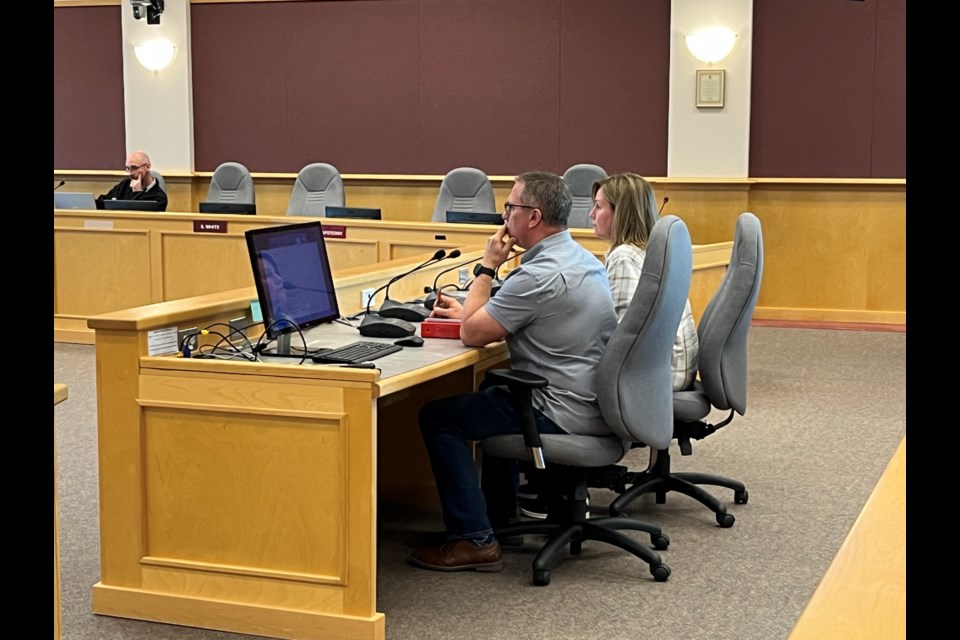 Regional District of Fraser-Fort George manager of inspection services Blaine Harasimiuk (left) and bylaw enforcement officer Corinne Hickman (right) discuss a proposal to hire a contractor to clean up debris and vehicles from the property at 8517 Chilcotin Rd. at a board of directors meeting in Prince George on Thursday, May 22, 2025. 